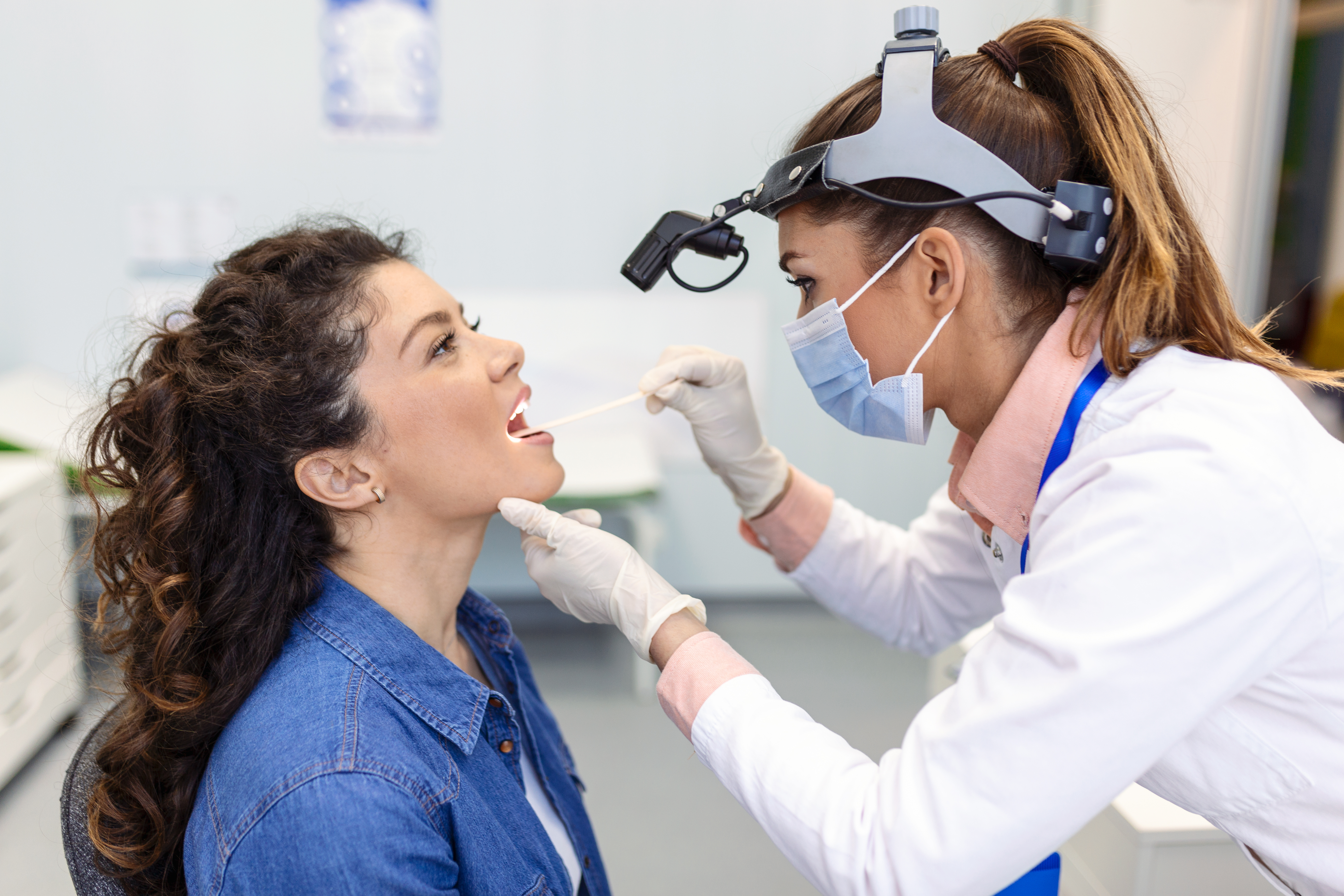 	doctor-using-inspection-spatula-examine-patient-throat-ent-doctor-doing-throat-exam-woman-patient-opened-her-mouth-throat-checkup